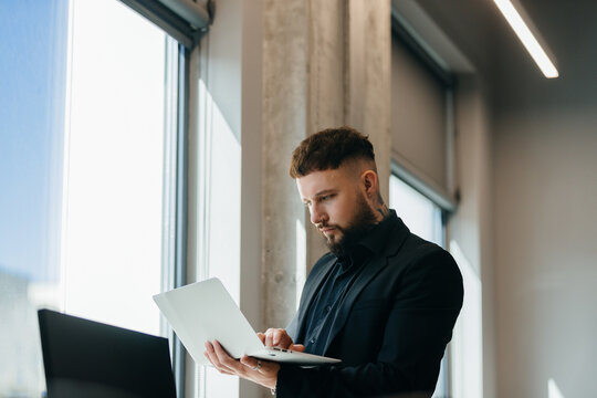 Young professional reviewing business data on laptop