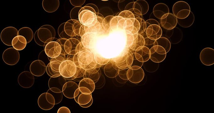 Abstract glow gold bokeh bubble particles flying on black background. Orange red gold bokeh particles dust fly in the air on super slow motion camera 1000 fps.