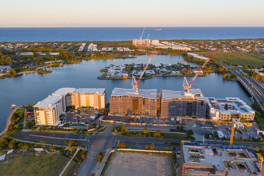 Aerial view of a new coastal development under construction along a canal