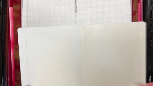 Natural paper dyeing process for junk journals and scrapbooking. White paper sheets are slowly dipped into a tray of vibrant red and pink vegetable dye.