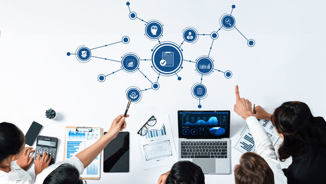 A dynamic business team engages in collaborative analysis of financial data with technology, supporting strategic planning and decision-making processes in the workplace. Amity