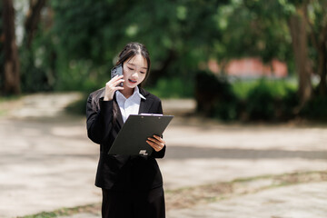 Happy young businesswoman working remotely from a cafe and having a business consultation on her...