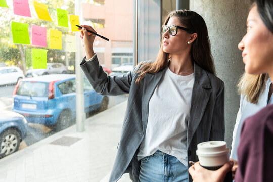 Businesswomen brainstorming in modern office setting