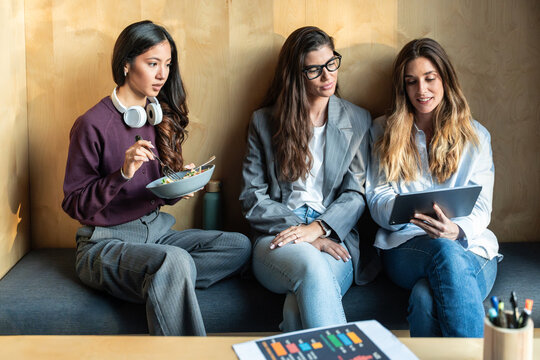 Businesswomen discussing creative ideas during lunch
