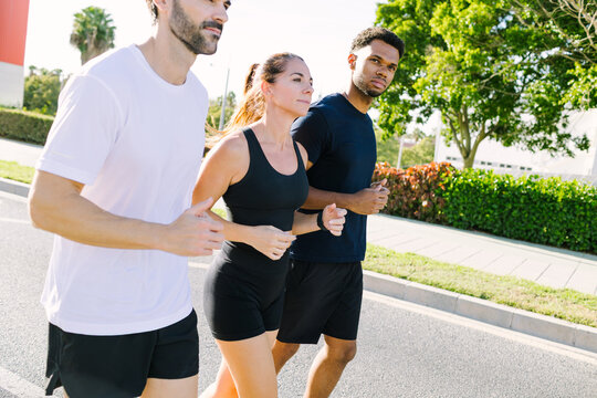Multiethnic friends enjoy jogging in urban setting