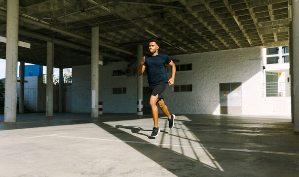 Young man jogging in urban setting for active lifestyle