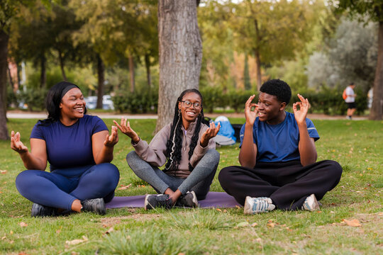 Friends enjoying meditation in a tranquil park setting