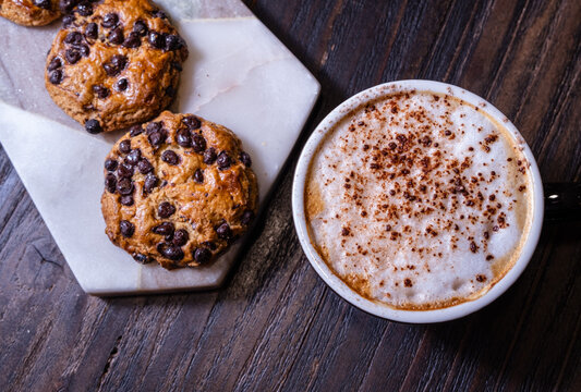Coffee and cookies on a rustic wooden table