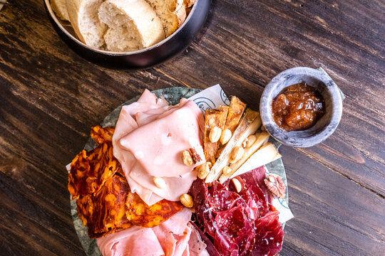 Charcuterie board with cured ham and accompaniments