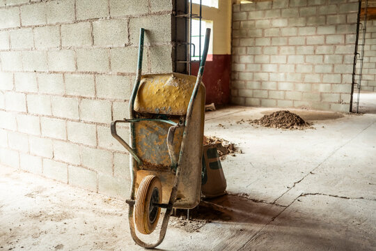 Construction site with wheelbarrow and concrete blocks