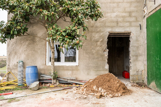 Building site with construction materials and open doorway