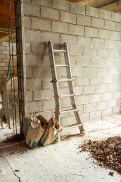 Concrete wall construction with ladder on building site