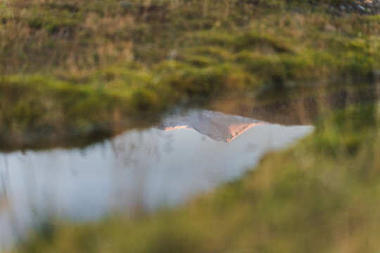 Reflection of snow-capped mountain in Icelandic landscape