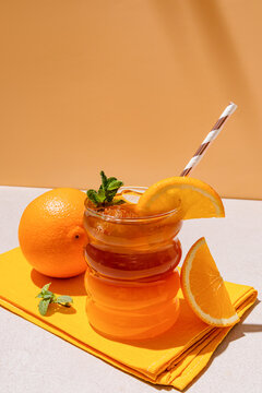 A refreshing iced citrus Americano with a vibrant orange slice garnish