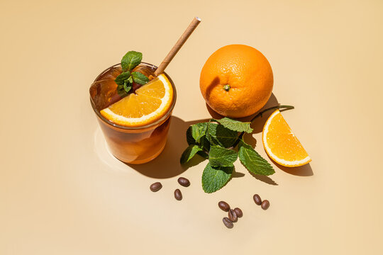 Iced citrus americano with mint and orange garnish