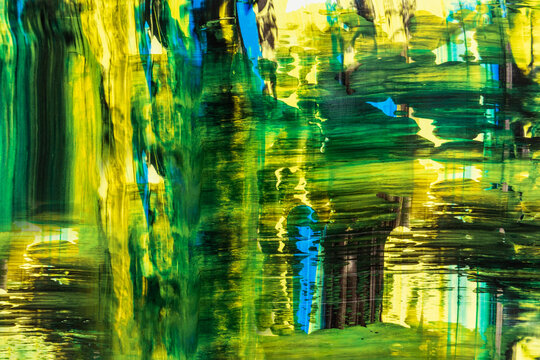 Vivid abstract acrylic paint background in green hues
