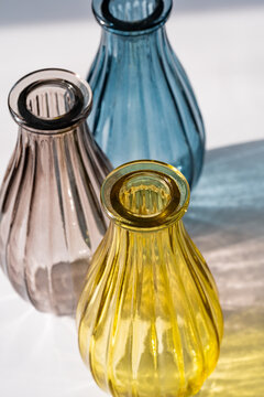 Elegant colorful glass vases casting gentle shadows