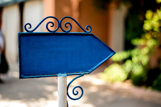 Blue right arrow sign with decorative elements