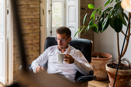 Male entrepreneur taking notes during coffee break