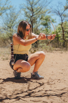 Woman exploring Namibia with a bow and arrow