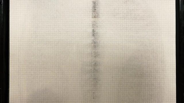 Natural paper dyeing process for junk journals and scrapbooking. A textured sheet of vintage paper is dipped into natural vegetable dye, creating a unique abstract pattern of golden brown and beige.