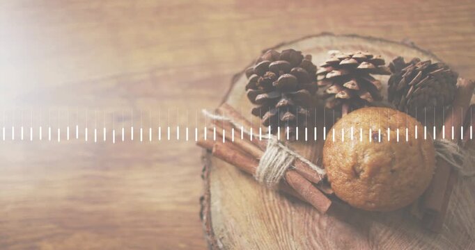 Audio starting causing waveform pulsing above pine cones, cinnamon sticks, muffin displaying rhythm