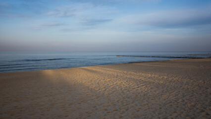 Empty Baltic Beach at Dusk with warm golden light on the sand