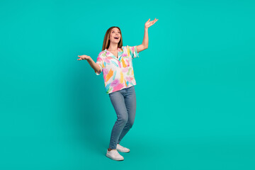 Young woman expressing vibrant energy with cheerful gestures against a turquoise background