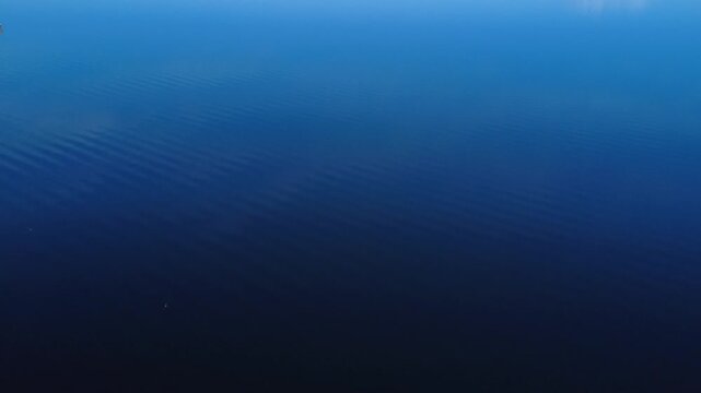 Exploring the Deep Blue Waters of a Lake During the Early Morning Hours With Gentle Ripples Reflecting Sunlight. Starnberg, Bavaria, Germany