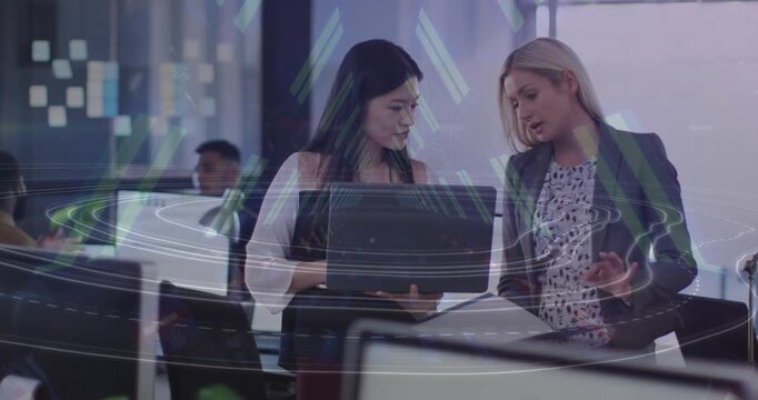 Animation of tunnel in seamless pattern over two diverse women discussing over a laptop at office
