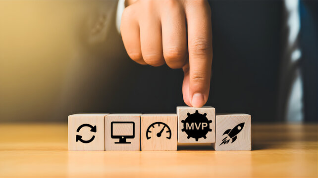 Agile methodology with MVP development process icons on wooden blocks symbolizing business growth and innovation