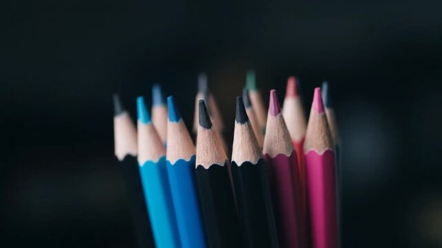 Close-up of sharpened colored pencils on a dark background