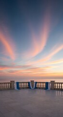 Fototapeta premium Beautiful sunset view from a stone terrace overlooking the calm sea
