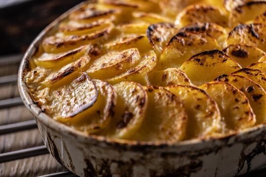 Golden-brown gratin potatoes, neatly arranged in a white ceramic bowl. However, in Slovakia, this dish is known primarily at home as French potatoes.