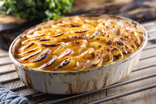 Golden-brown gratin potatoes, neatly arranged in a white ceramic bowl. However, in Slovakia, this dish is known primarily at home as French potatoes.