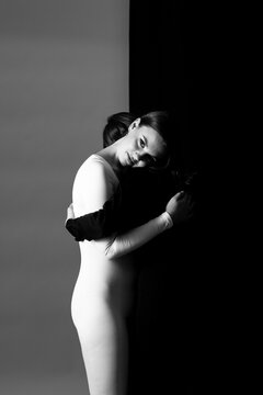 Zwei Frauen in schwarzem und wei&szlig;en Overall umarmen sich vor schwarz-wei&szlig;em Hintergrund