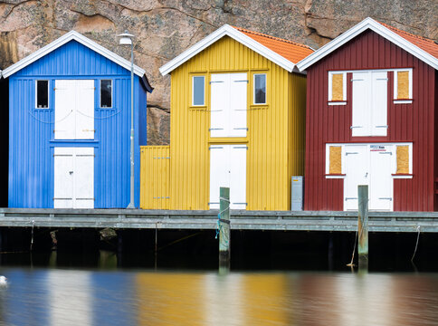 Colorful wooden fishing huts on the harbor in Sm&ouml;gen Sweden