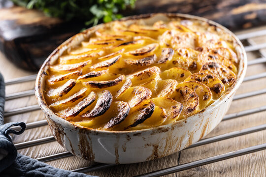 Golden-brown gratin potatoes, neatly arranged in a white ceramic bowl. However, in Slovakia, this dish is known primarily at home as French potatoes.