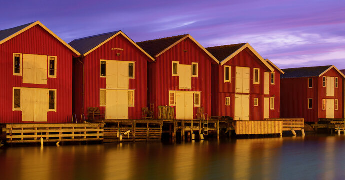 Red wooden boathouses at night in Sm&ouml;gen Sweden harbor