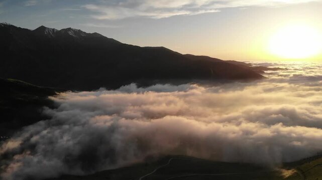 Sunrise Above Sea Of Clouds With Mountain Silhouette And Warm Golden Light, Fog Inversion Fills Valley
