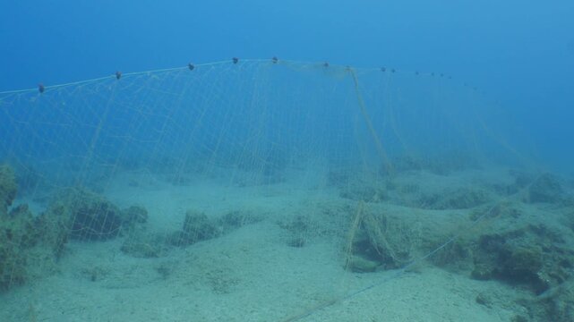 old fish net underwater ghost hunting pollution of oceans by driftnets