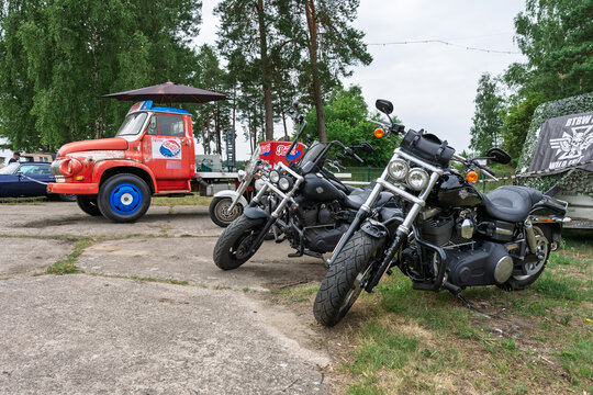 FINOWFURT, GERMANY &ndash; JUNE 28, 2025: Two Harley‑Davidson motorcycles with Ford FK 3500 in background. Roadrunner's Paradise Race 61 Festival.