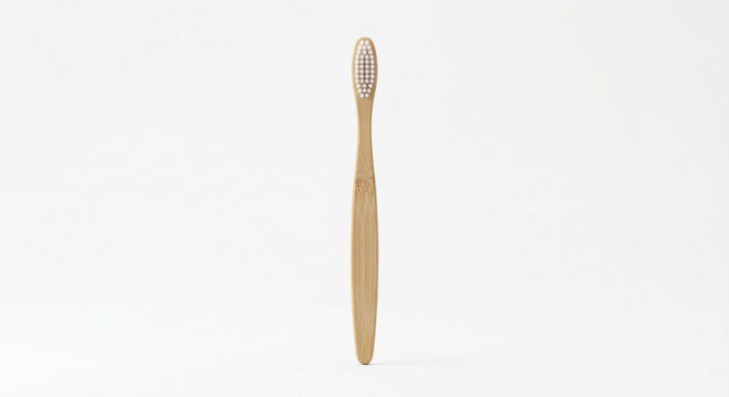 Minimalist bamboo toothbrush with white bristles isolated on pure white background