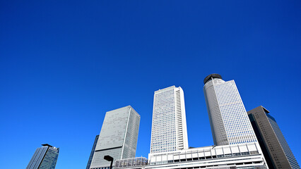 Obraz premium Nagoya Station, looking up at the skyscrapers against the blue sky.（名古屋駅）6