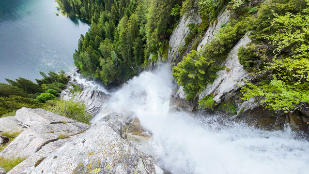 Aerial view of cascata della regina del lago waterfall plunging into lake malga boazzo