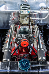 Custom engine bay detail with polished carburetors and exposed intake pipes. © Sergey Kohl