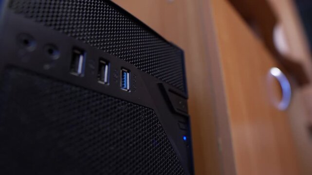 A flash drive is pulled out of a computers USB port in an office, close-up view, technology
