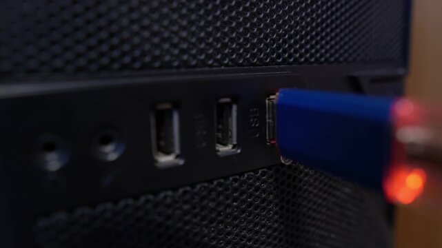 The flash drive is inserted into the computer's USB port, close-up view