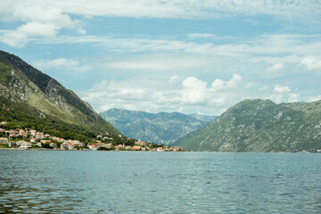 Obraz premium Kotor, Montenegro, July 30 2014: Stunning view of Kotor Bay surrounded by mountains, showcasing tranquil waters and picturesque coastal village