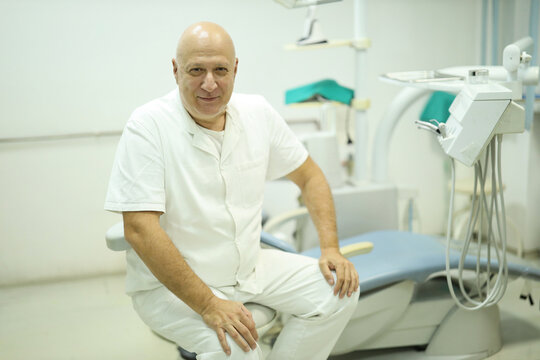 Professional Dentist Sitting in Modern Dental Clinic. Healthcare concept oral hygiene advice